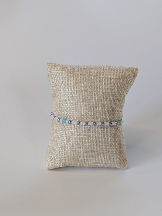 Bracelet on a textured pillow against a plain background